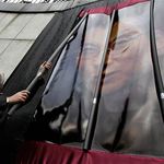Near the U.N., Richard Gere removes symbolic prison bars from in front of a photograph of Liu